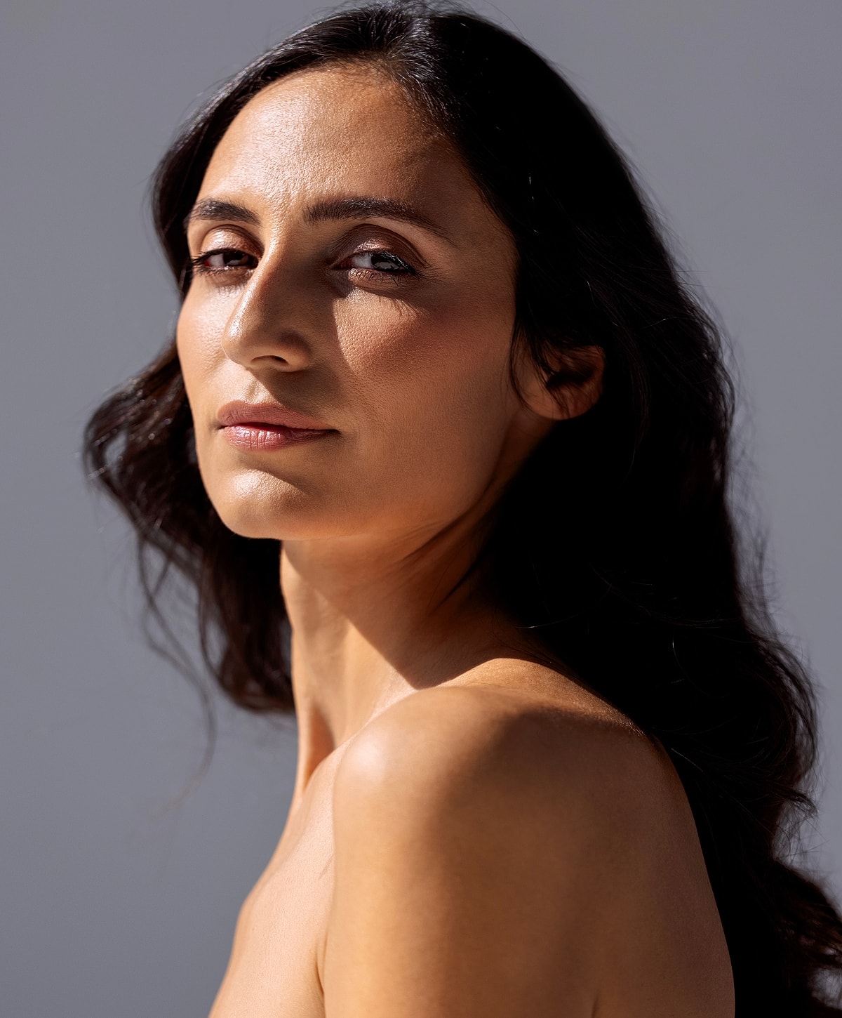 Smiling person enjoying a sunny moment outdoors.