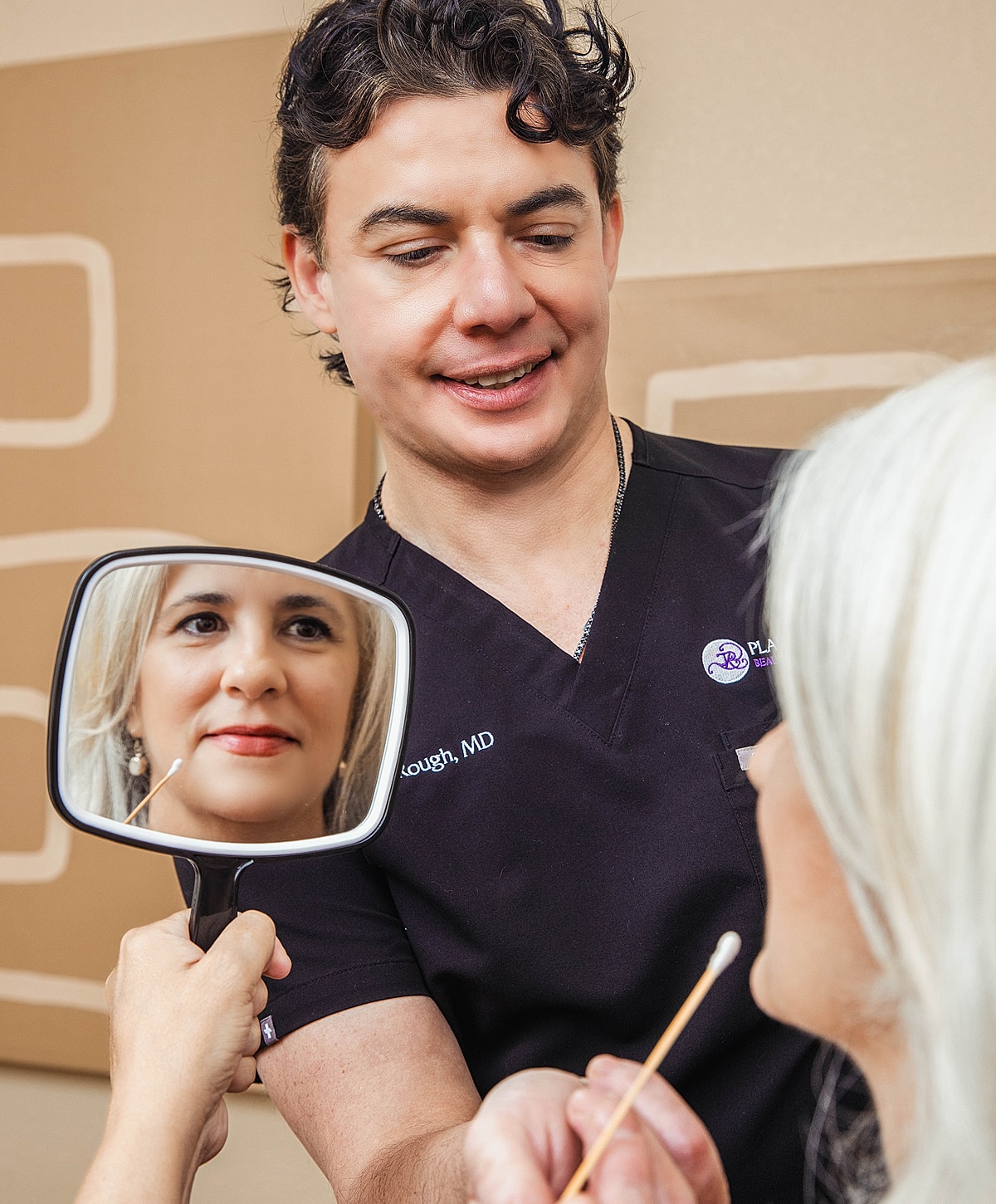 Doctor consulting patient with mirror reflection.