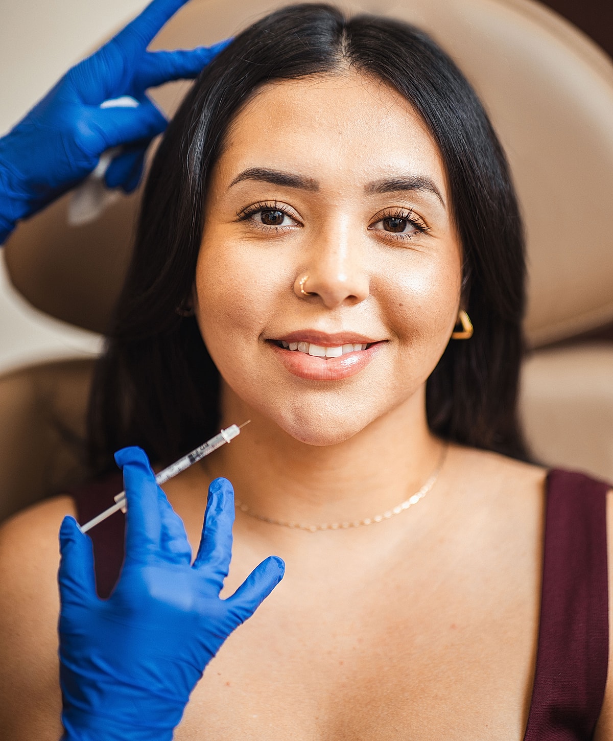 Woman receiving cosmetic treatment with syringe.