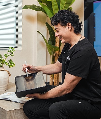 Person using tablet with stylus in clinic.
