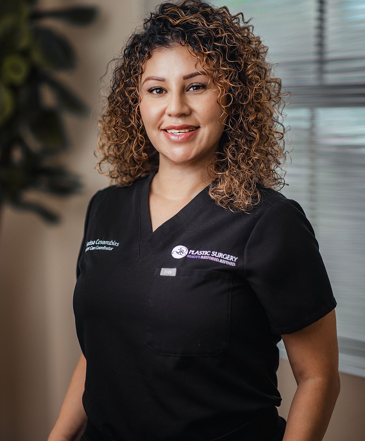 Model in black swimsuit posing confidently.