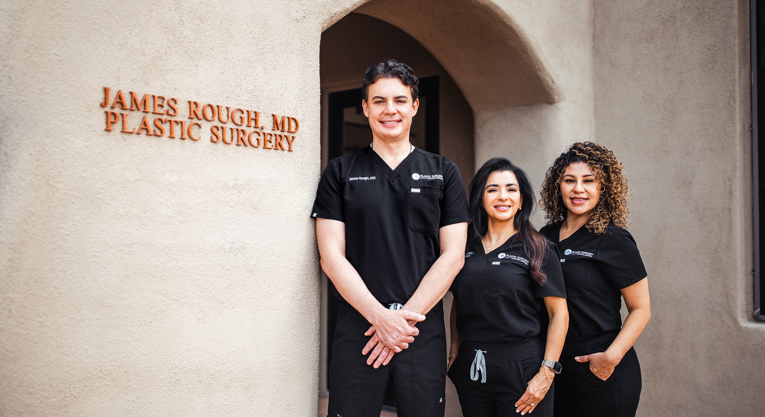 Medical team outside plastic surgery clinic.