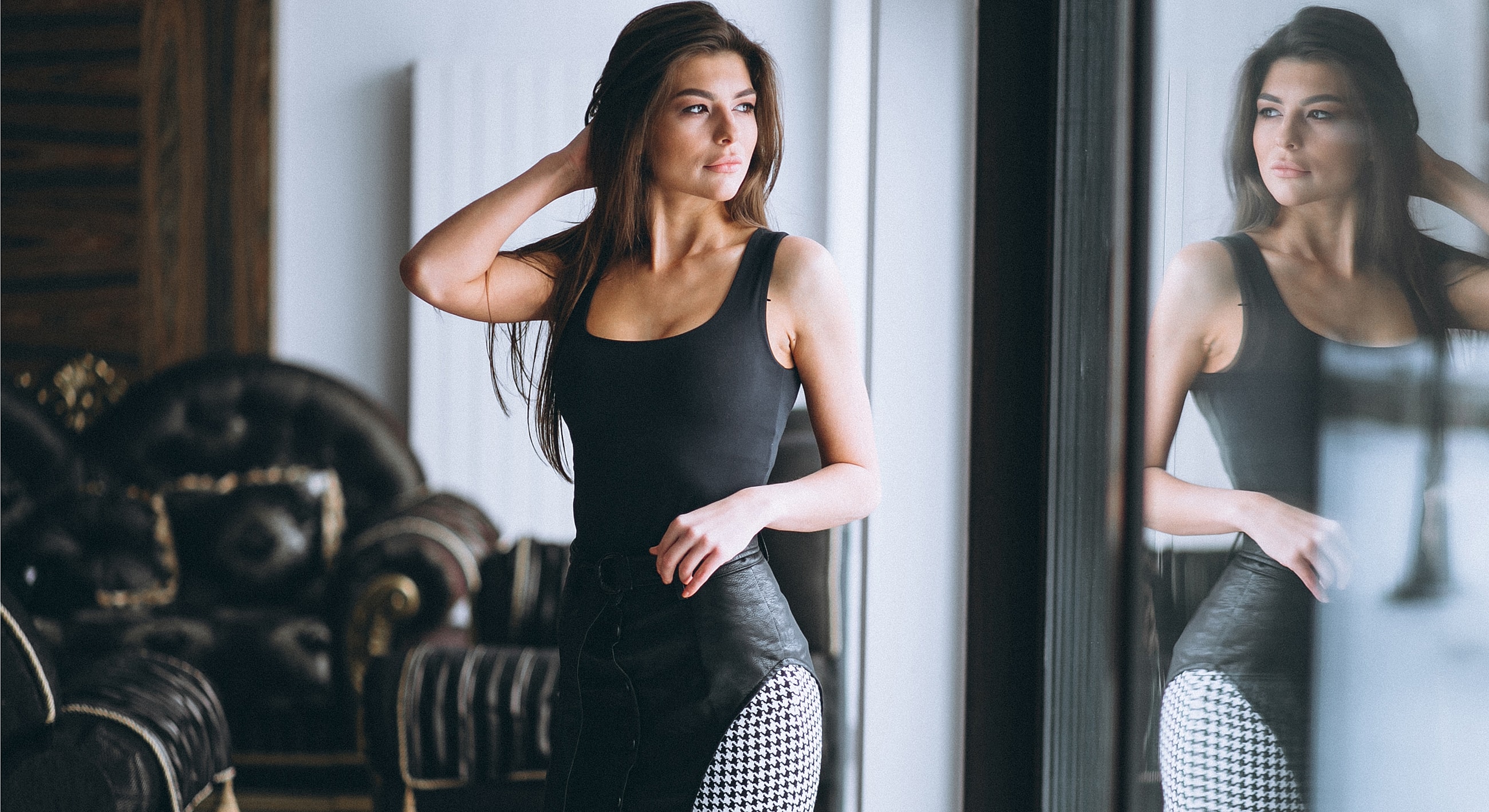 Woman in stylish outfit by the window.