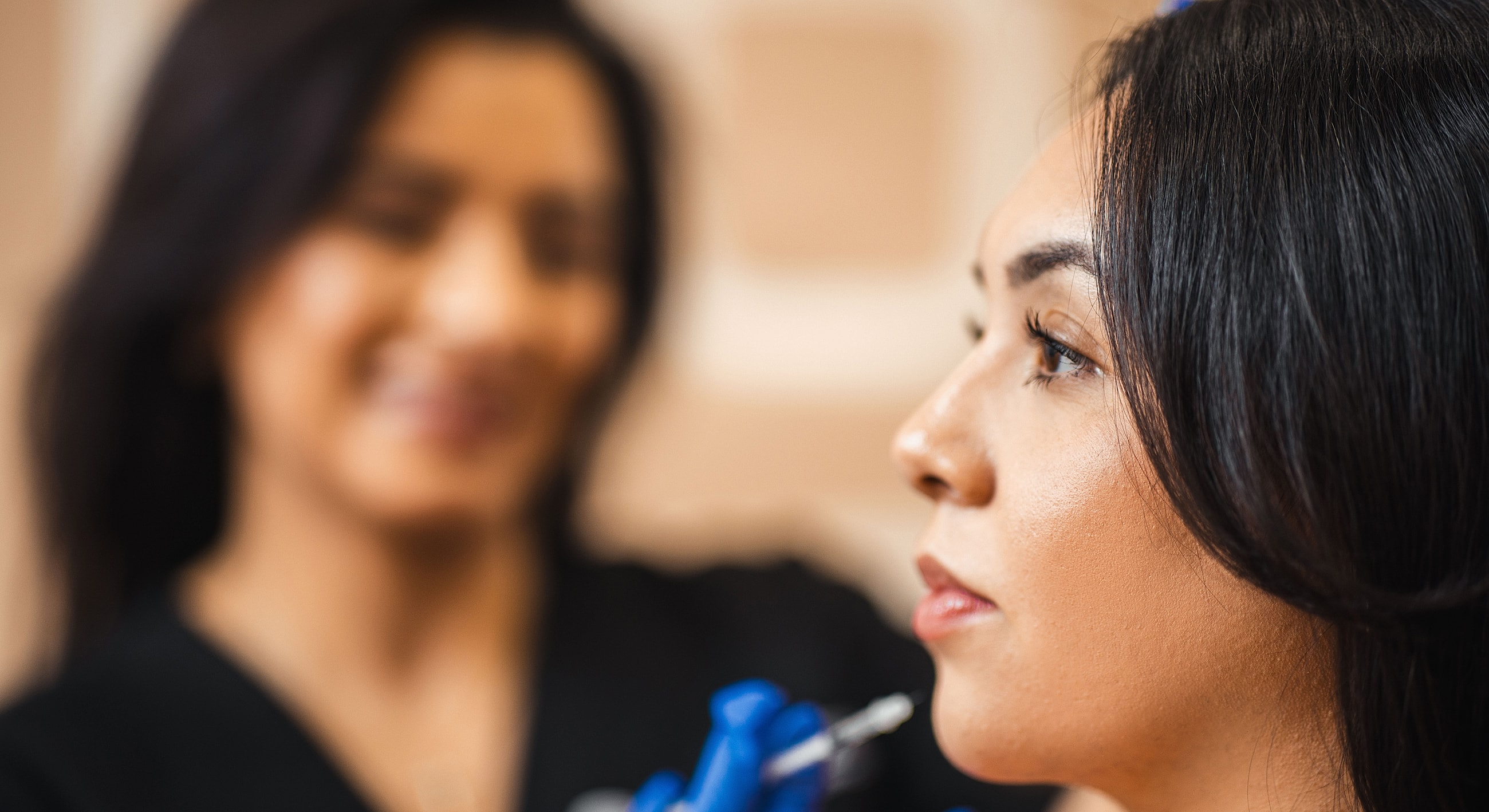 Woman receiving cosmetic treatment in a salon.