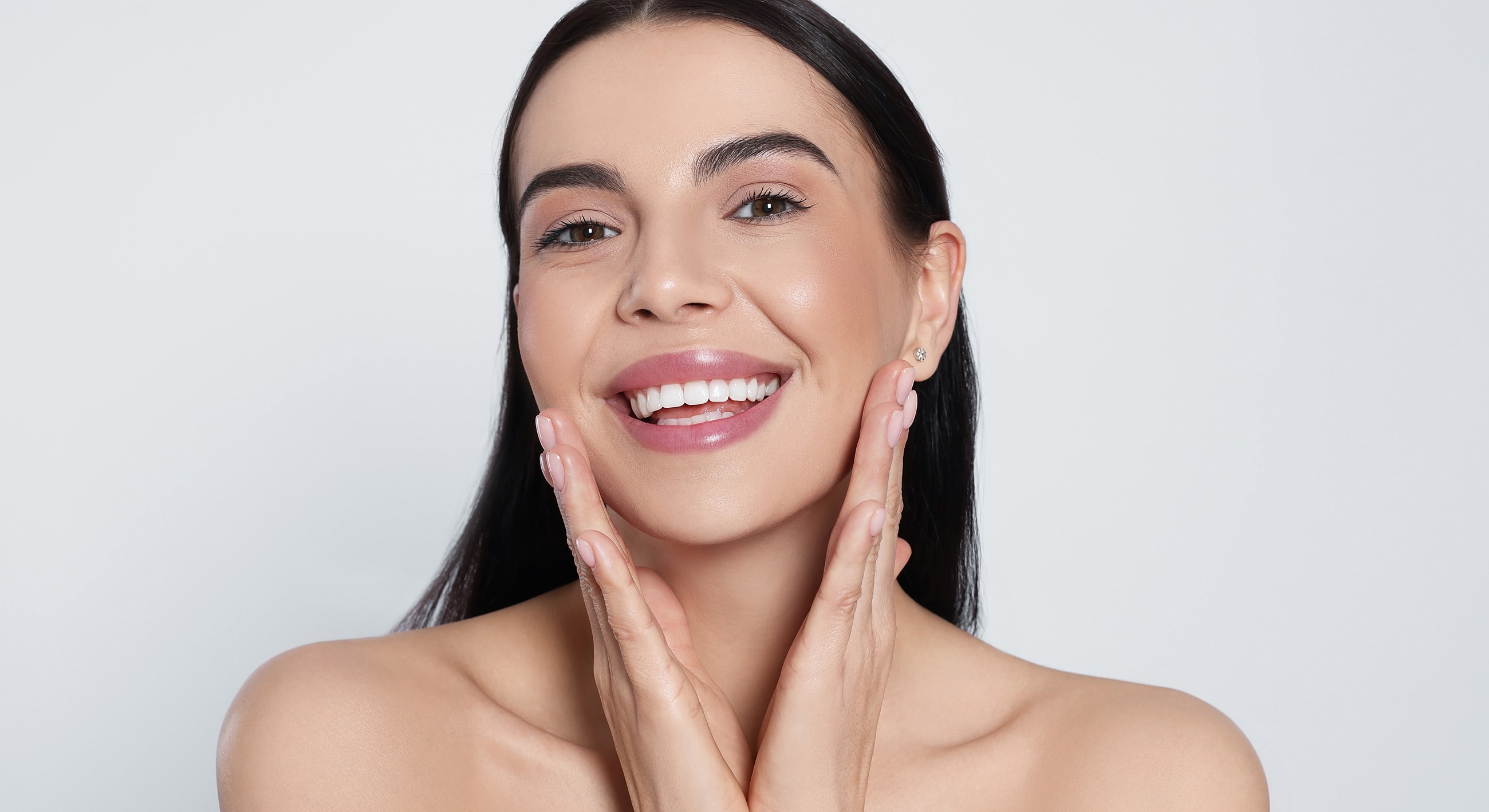 Smiling woman showcasing healthy, glowing skin.