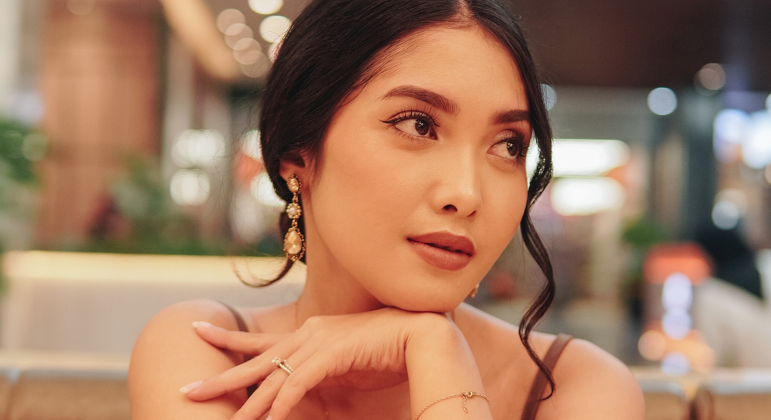 Thoughtful young woman with elegant accessories.
